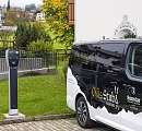 Electric charging station next to the Chäs Stuba electric bus at Sunstar Hotel Klosters – sustainable mobility in everyday hotel operations.